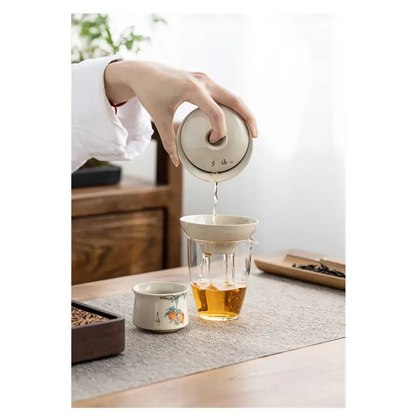 Porcelain tea strainer with tea cup and saucer