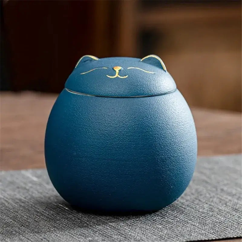 Blue ceramic tea canister with cat design