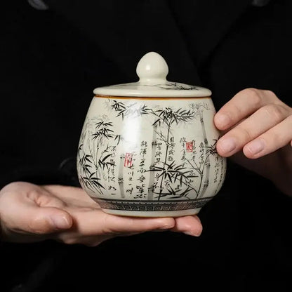 Artisan hand-thrown ceramic tea canister with brushwork bamboo forest scene
