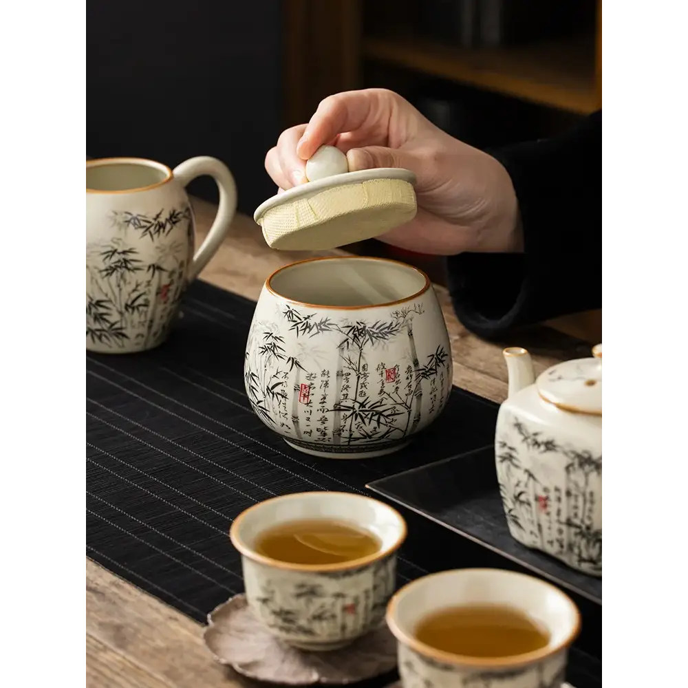 Ceramic tea storage jar with hand-painted bamboo motif and natural bamboo lid