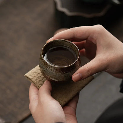 Wheel-thrown stoneware cup side view with visible kiln texture variations