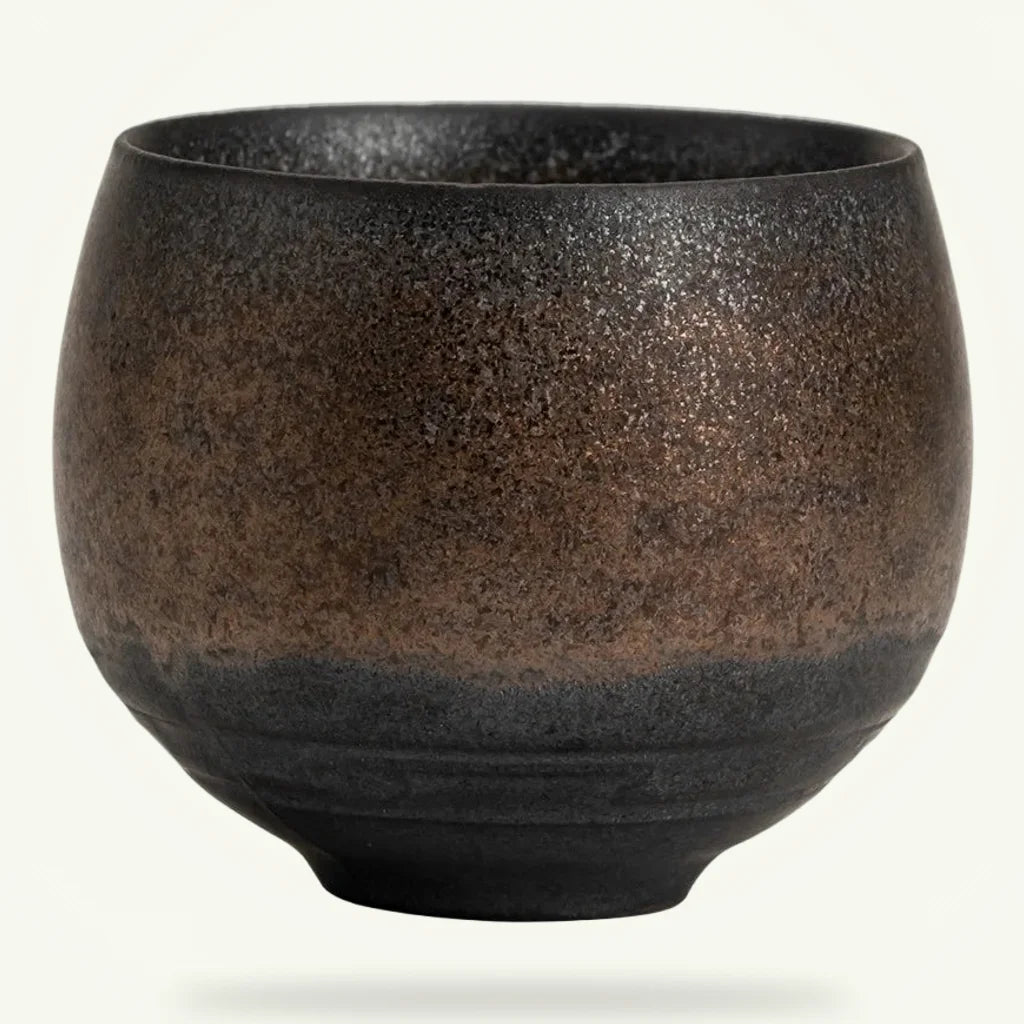 Handmade Japanese stoneware tea cup, wheel-thrown with half glaze, packshot on plain background