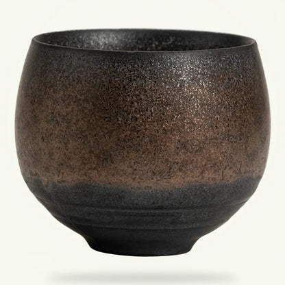 Handmade Japanese stoneware tea cup, wheel-thrown with half glaze, packshot on plain background