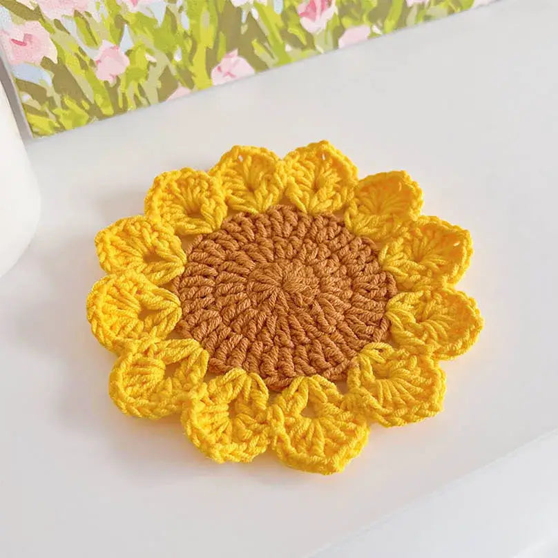 Sunflower crochet coaster set on wooden table
