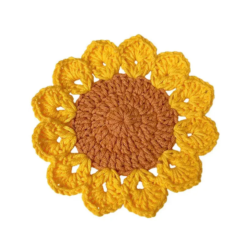 Close-up of handmade sunflower crochet coaster
