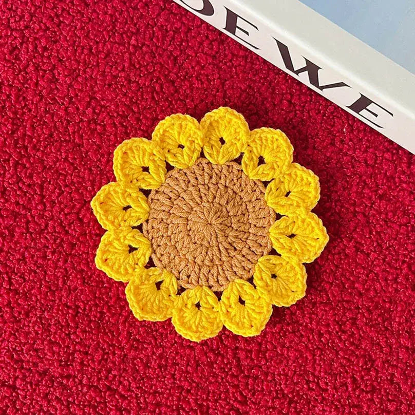 Yellow and brown crochet coaster under a mug