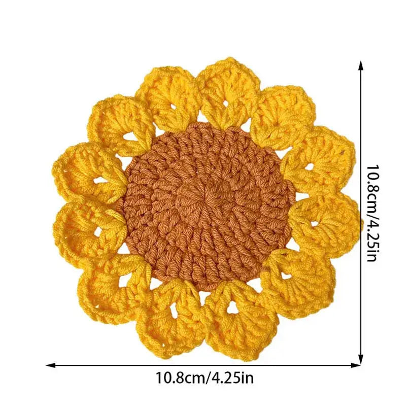 Stack of sunflower crochet coasters on table