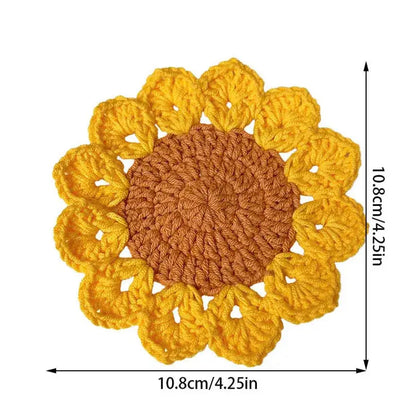 Stack of sunflower crochet coasters on table