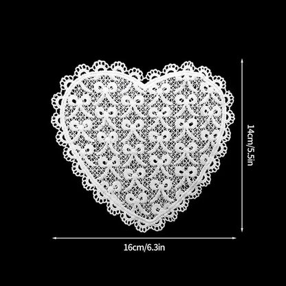 Lace heart patterned absorbent cotton coaster with teacup on linen tablecloth