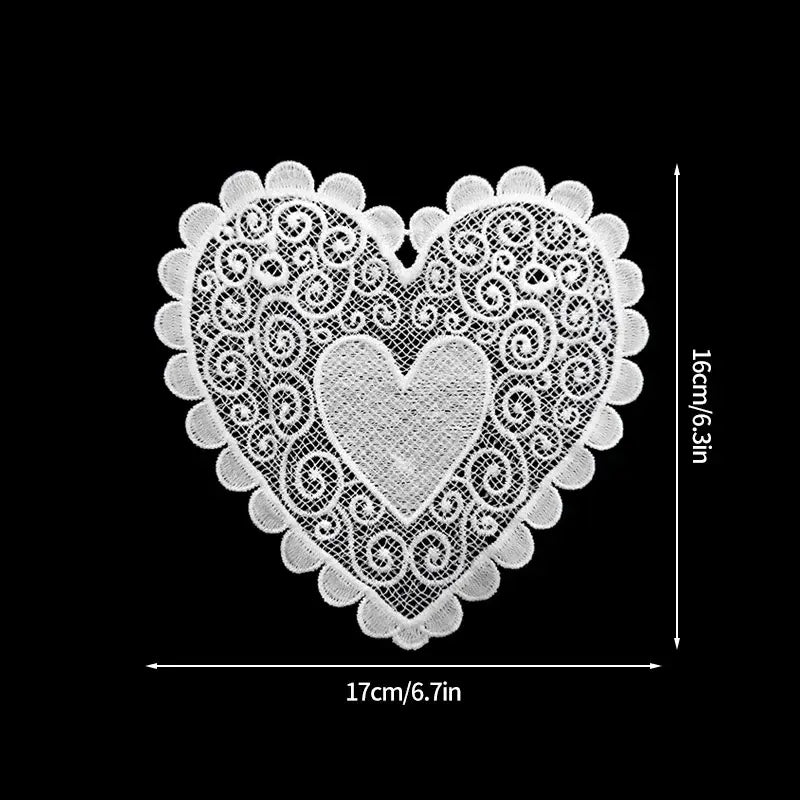 Two heart-shaped cotton tea coasters side by side showing pattern detail and stitching