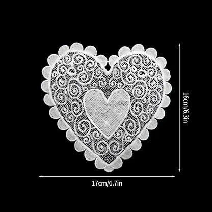 Two heart-shaped cotton tea coasters side by side showing pattern detail and stitching