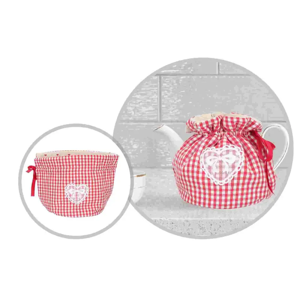 Heart design teapot cozy on kitchen counter beside a teacup