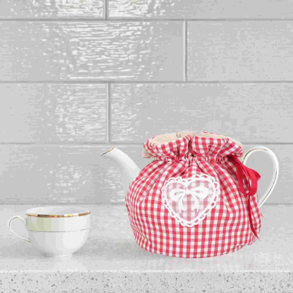 Padded cotton teapot warmer with repeating heart print