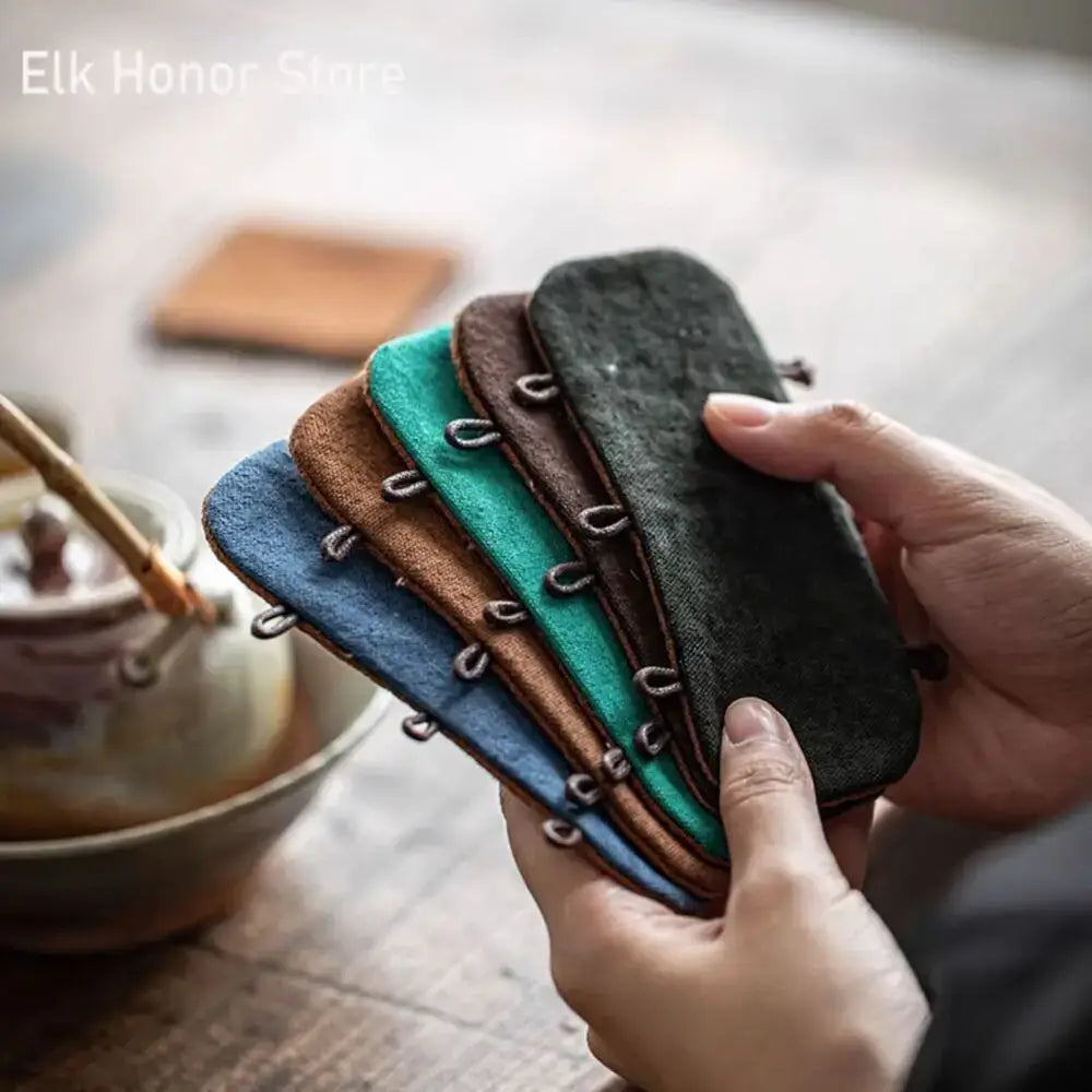 Insulating cotton teapot handle cover in black on a teapot