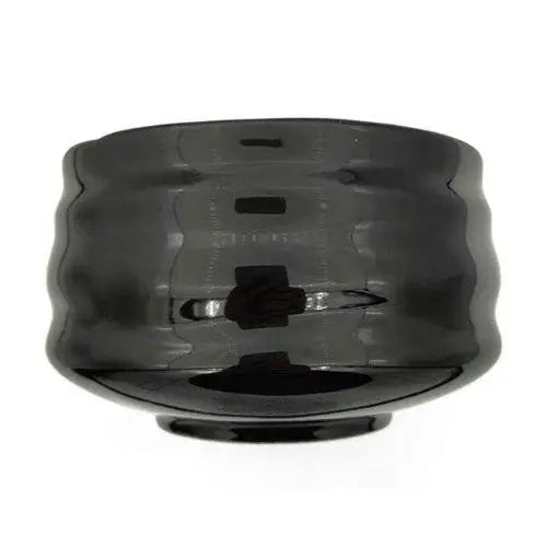 Black ceramic chawan with matcha whisk and powder