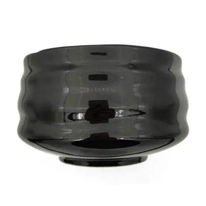 Black ceramic chawan with matcha whisk and powder