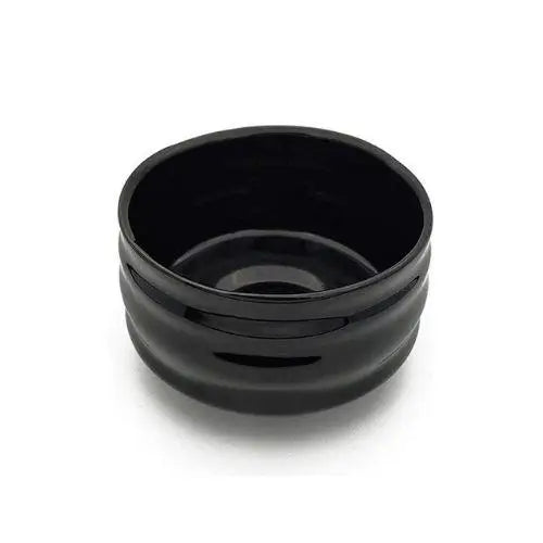 Black chawan bowl with matcha tea being poured