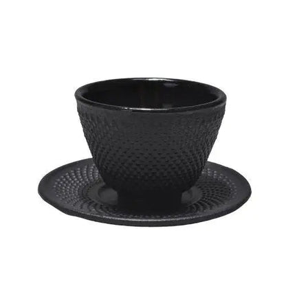 Two Japanese cast iron teacups with saucers side by side