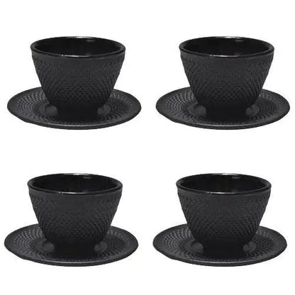 Four Japanese cast iron teacups with saucers arranged for tea ceremony