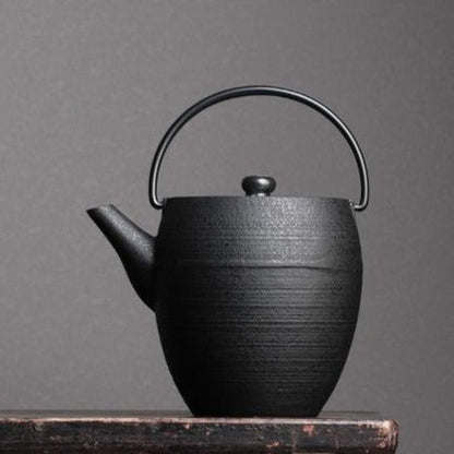 Enamel-coated cast iron teapot black finish, side handle detail