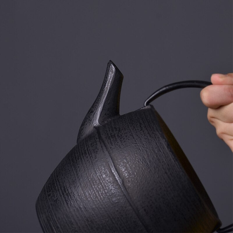 Black cast iron teapot with small Japanese tea cups, table setting