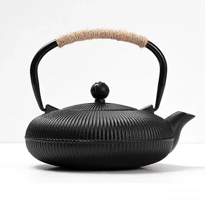 Japanese cast iron teapot with tea cup and leaves