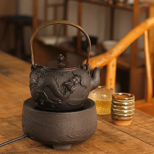 Raised dragon relief detail on black cast iron teapot surface