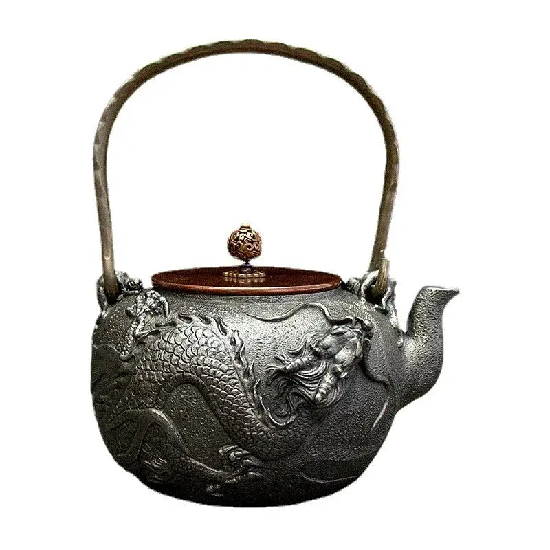 Cast iron dragon teapot pouring hot tea into ceramic cup