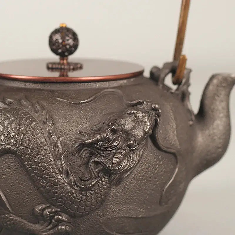 Japanese cast iron dragon teapot on dark wooden serving tray