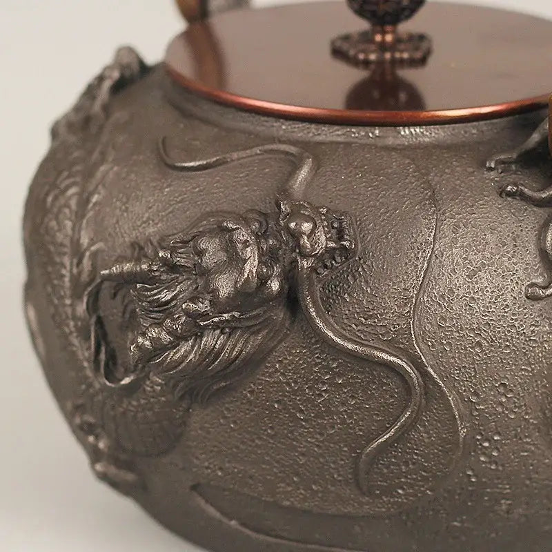 Cast iron tetsubin dragon design with steam rising from spout