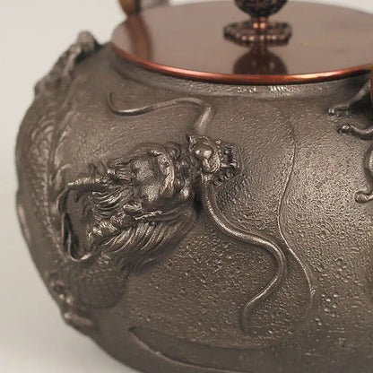Cast iron tetsubin dragon design with steam rising from spout