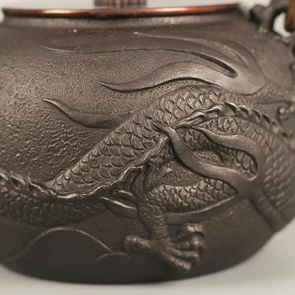 Cast iron teapot dragon handle and spout detail, black iron texture