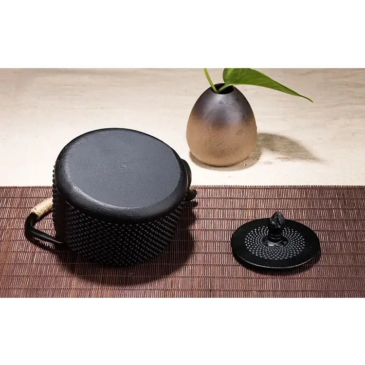 Traditional Japanese cast iron teapot 800ml styled with loose leaf tea and ceramic cup