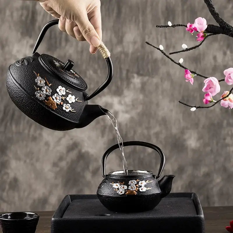 Japanese cast iron teapot with white plum blossom design