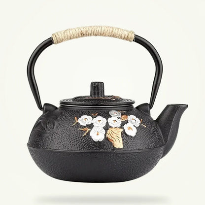 Japanese Cast Iron Teapot with White Plum Blossom Design, product photo on a plain background