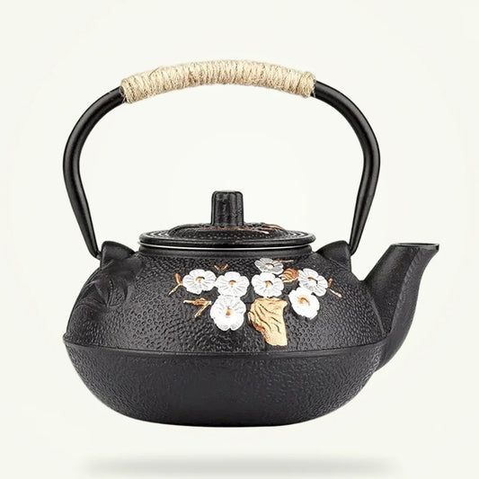 Japanese Cast Iron Teapot with White Plum Blossom Design, product photo on a plain background