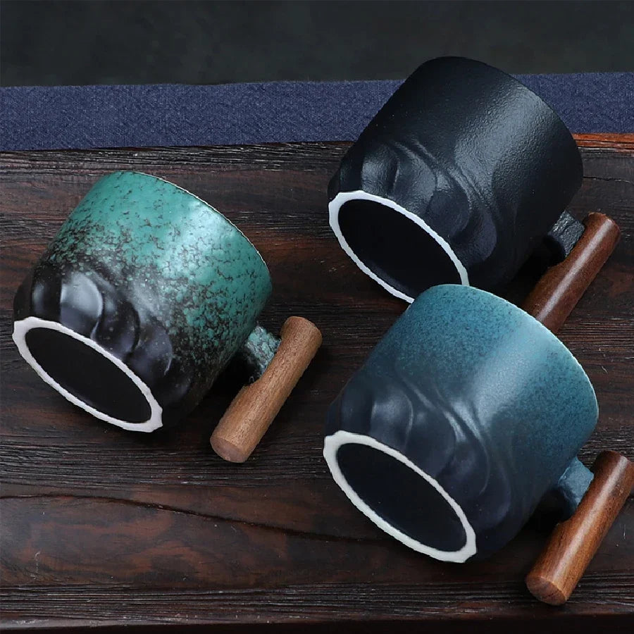 Forest green Japanese ceramic tea cup with wooden handle on a wooden surface