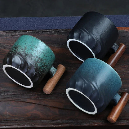 Forest green Japanese ceramic tea cup with wooden handle on a wooden surface
