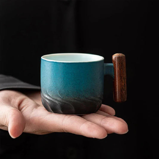 White glazed Japanese ceramic tea cup with natural wood handle, side profile