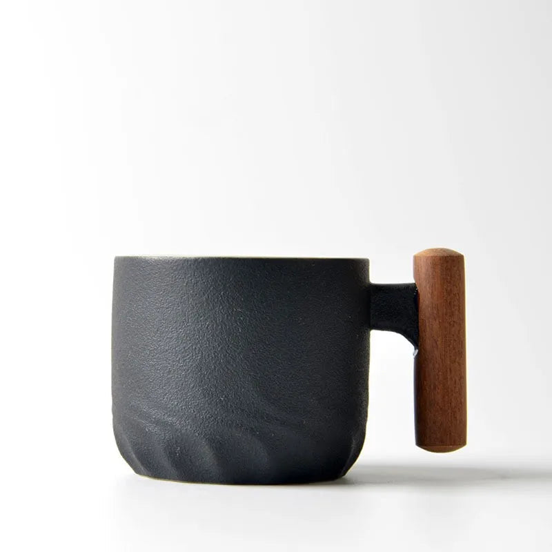 Japanese ceramic tea cup with wooden handle filled with freshly brewed green tea