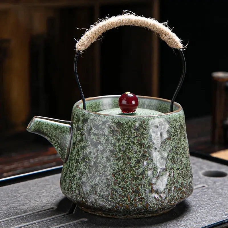 Green Japanese ceramic teapot with hand-painted details
