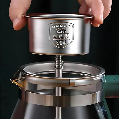 Electric teapot with infuser brewing loose-leaf tea in a kitchen setting