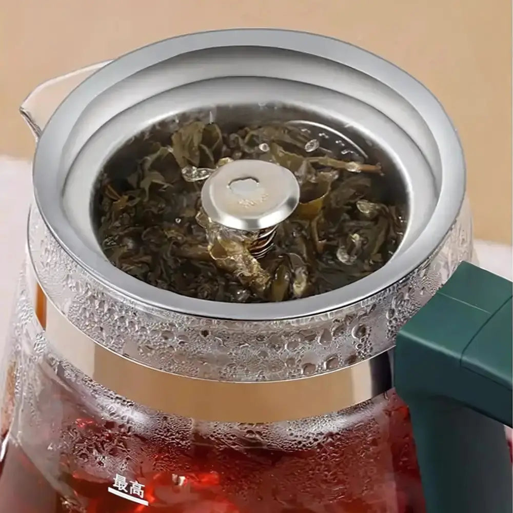 Close-up of removable stainless steel infuser with loose tea leaves inside