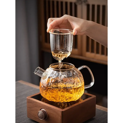 Glass teapot brewing loose leaf tea showing amber steep color
