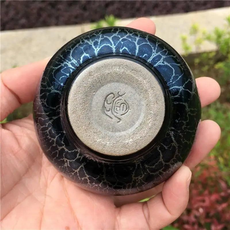 Hand-thrown Tenmoku tea bowl, bottom foot ring and stoneware body detail