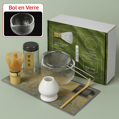 Glass bowl and bamboo matcha tools arranged on natural wooden surface