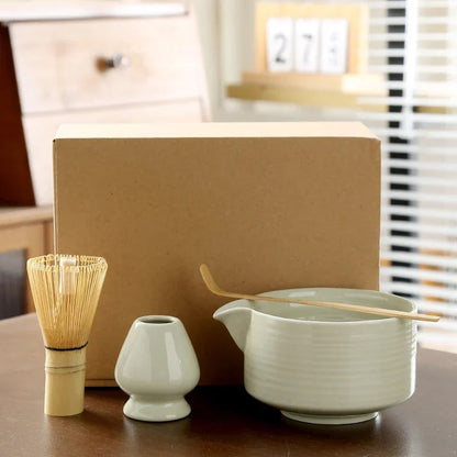 Ceramic matcha bowl and bamboo chasen set arranged on wooden table ready to use