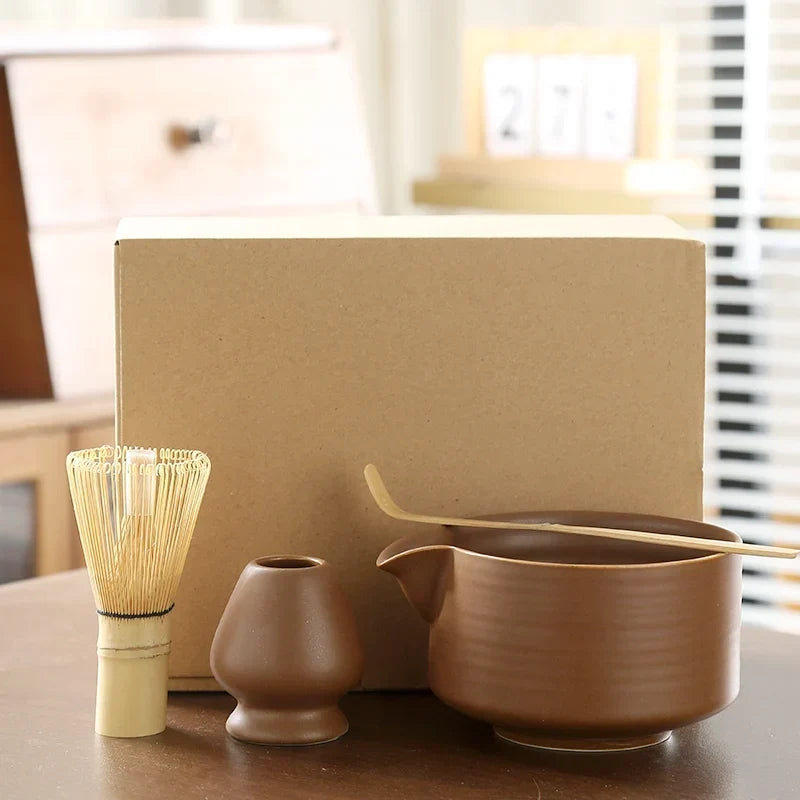 Whisking matcha powder in ceramic bowl with bamboo chasen to create green froth