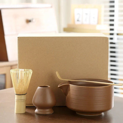 Whisking matcha powder in ceramic bowl with bamboo chasen to create green froth