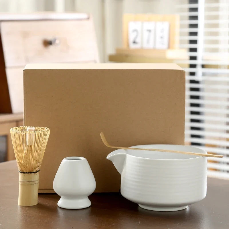 Japanese matcha set in deep glaze with bamboo chasen whisk resting on ceramic holder